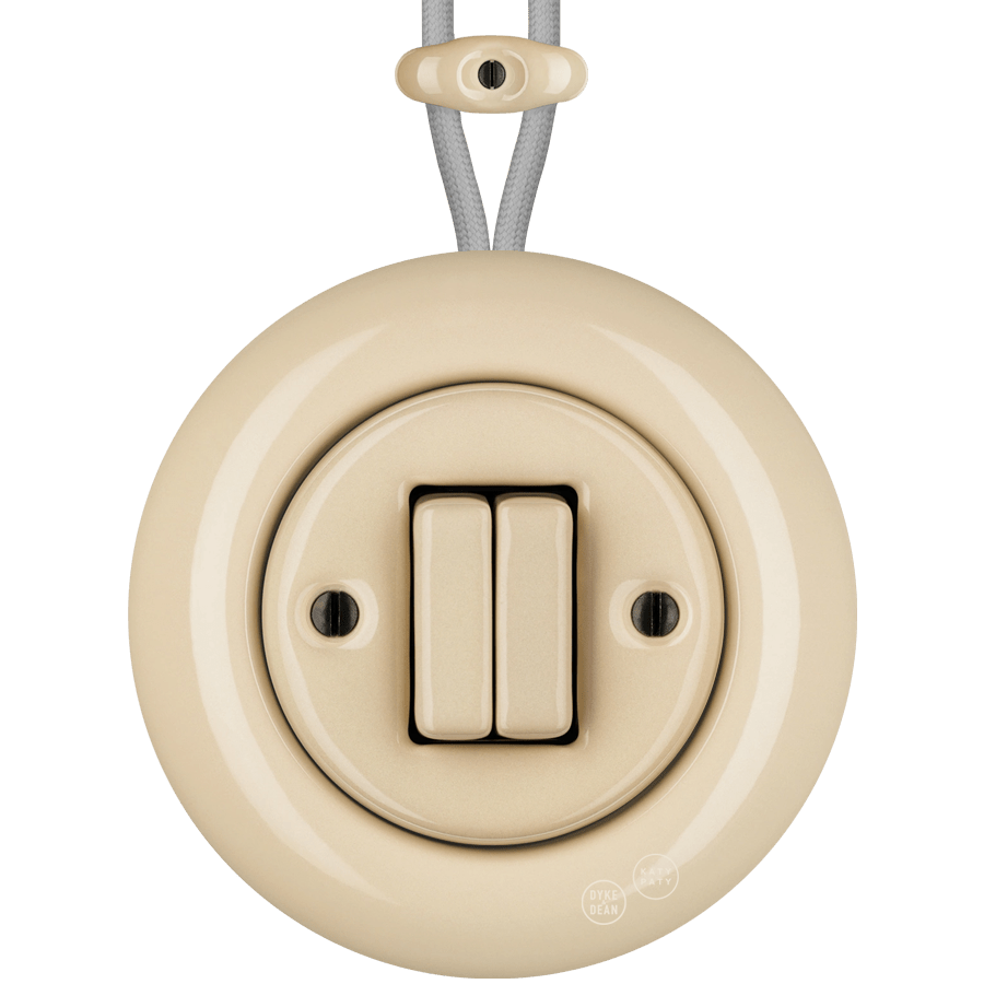 PORCELAIN KATY PATY COLONA ROUND SURFACE MOUNTED DOUBLE SLIM BUTTON SWITCH SAND - DYKE & DEAN